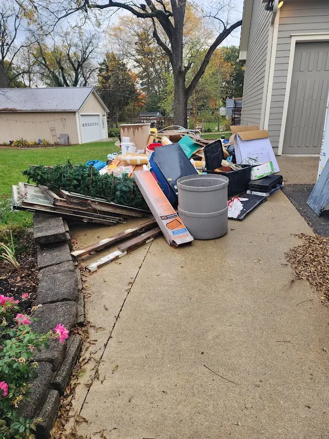 Dumpster being loaded with debris for 3 Yard Dumpster Rental in Hopkinton